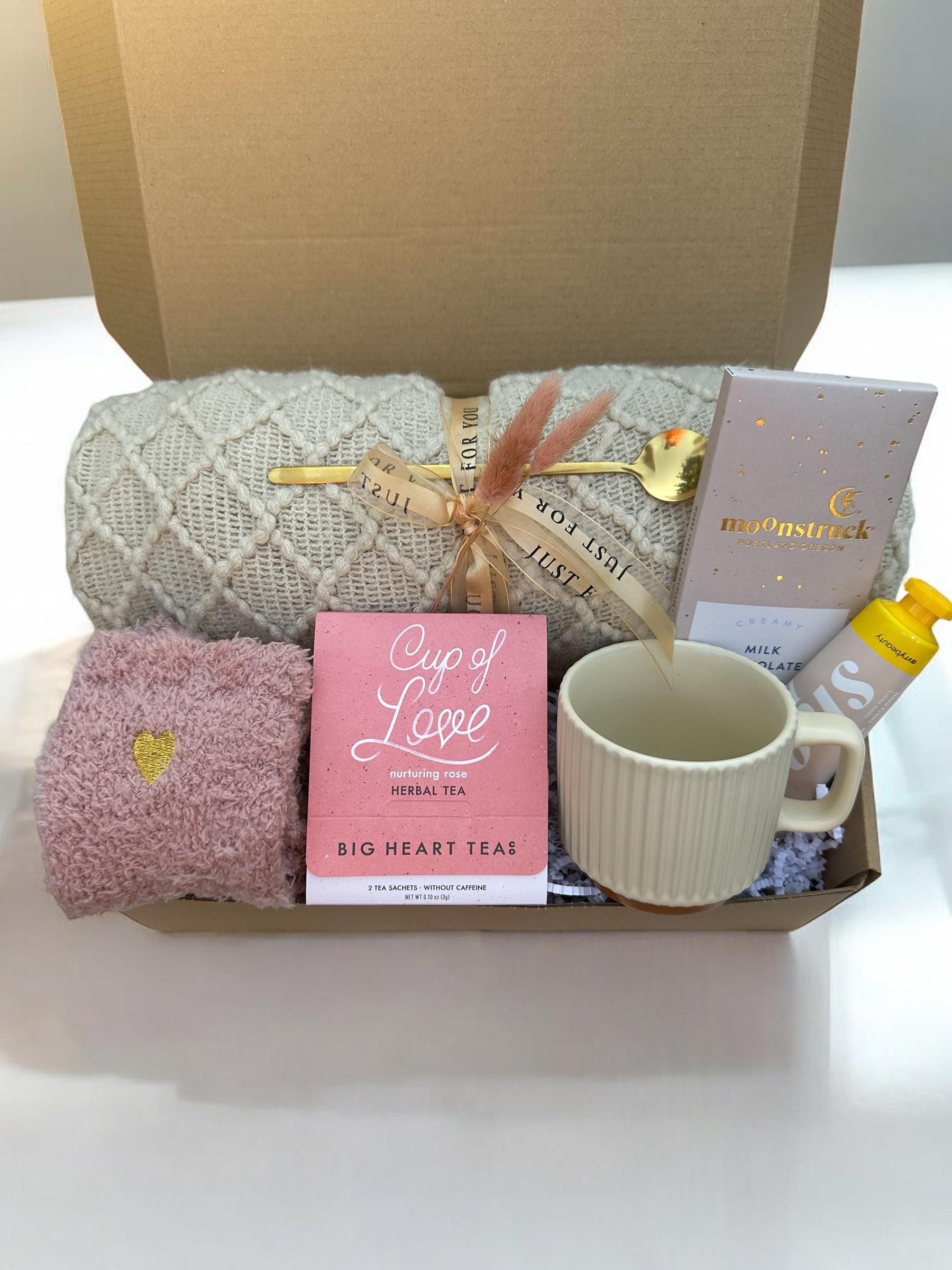 a box with a blanket, mug, and other items