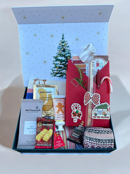 a christmas gift box filled with lots of goodies
