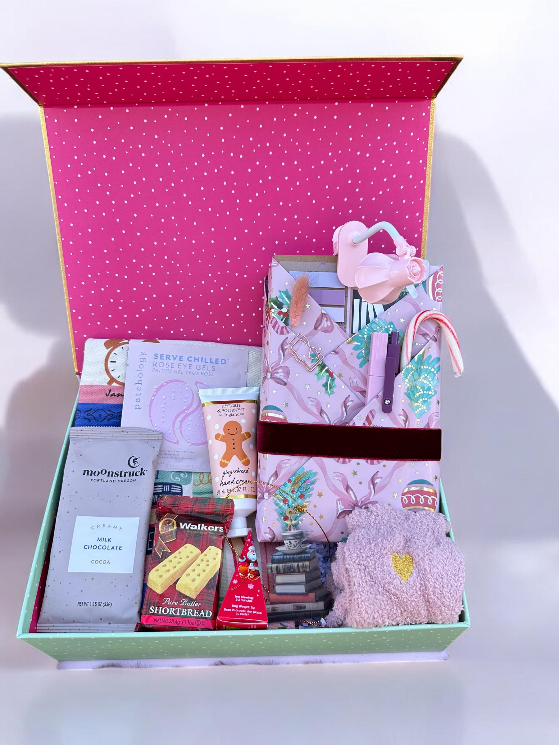 a pink suitcase filled with lots of items