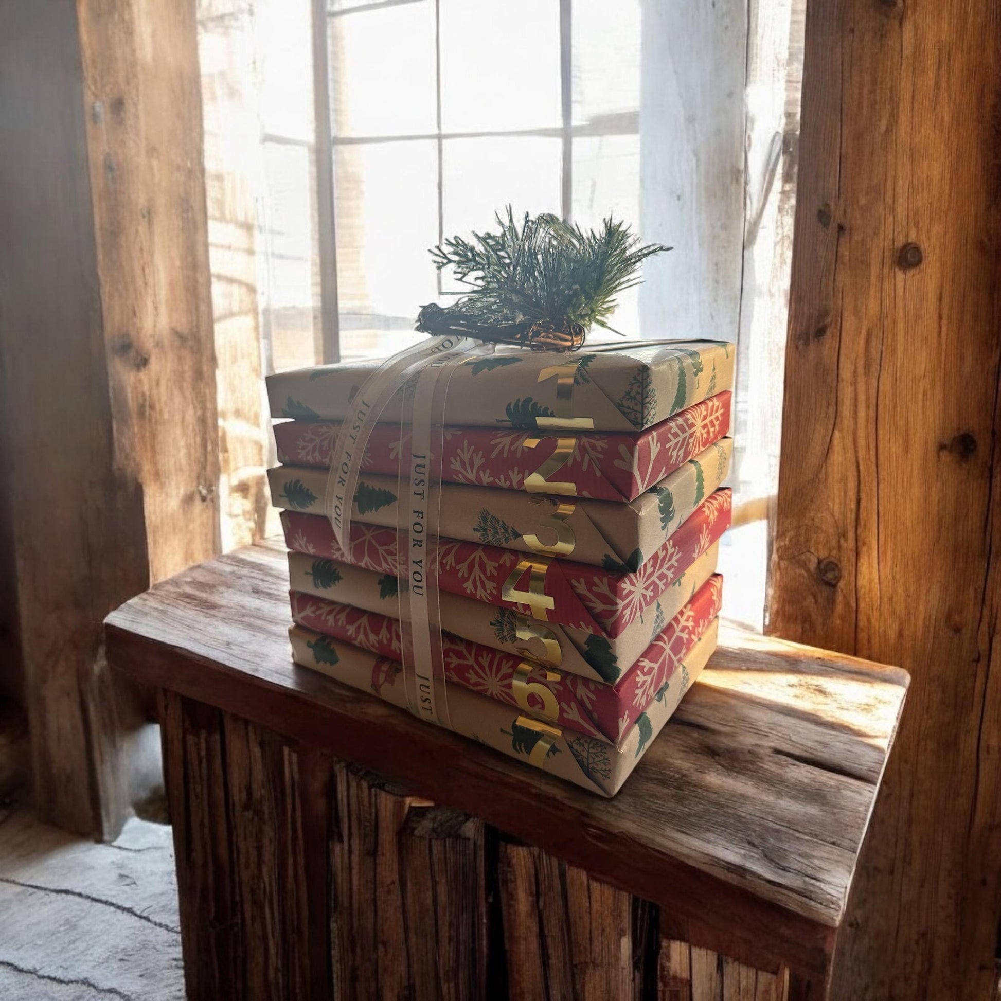 a stack of wrapped presents sitting on top of a wooden table